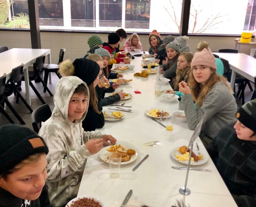 Students eating breakfast around table