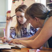 Teacher and student working on a written problem together