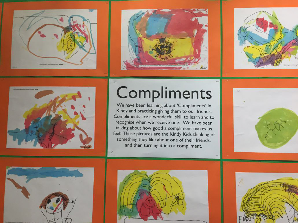 Poster of Compliments and pictures made by kids.