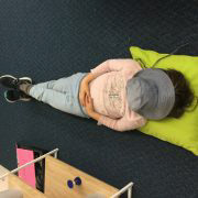 A child lying on the floor doing mindfulness