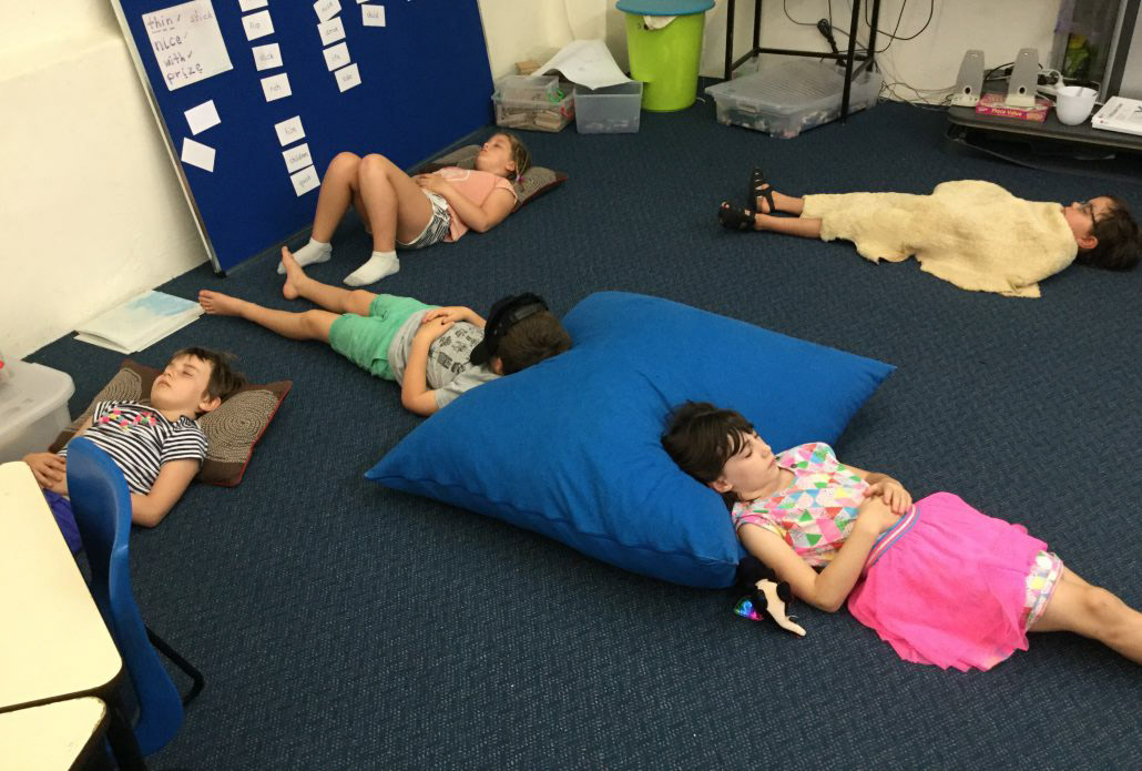 Kids lying on the floor doing mindfulness