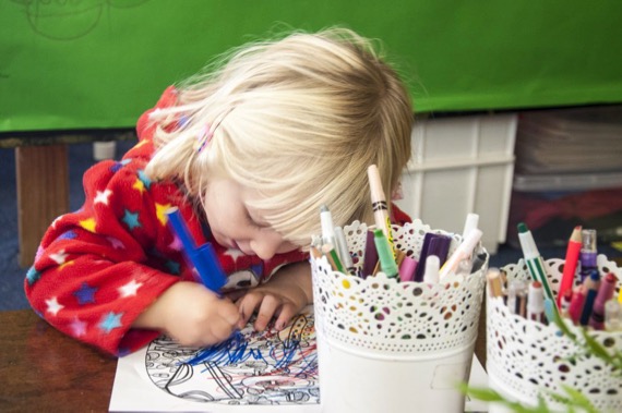 student drawing student colouring in