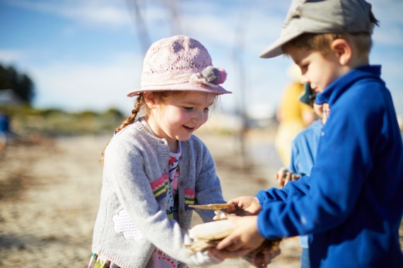 Students playing with sand at Beach School