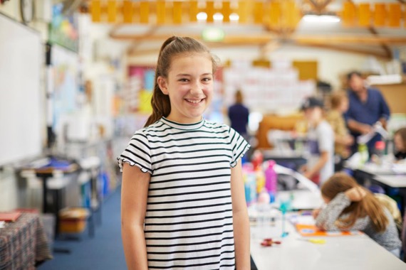 student in class room happy in school