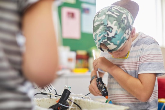 Student with glue gun student with glue gun
